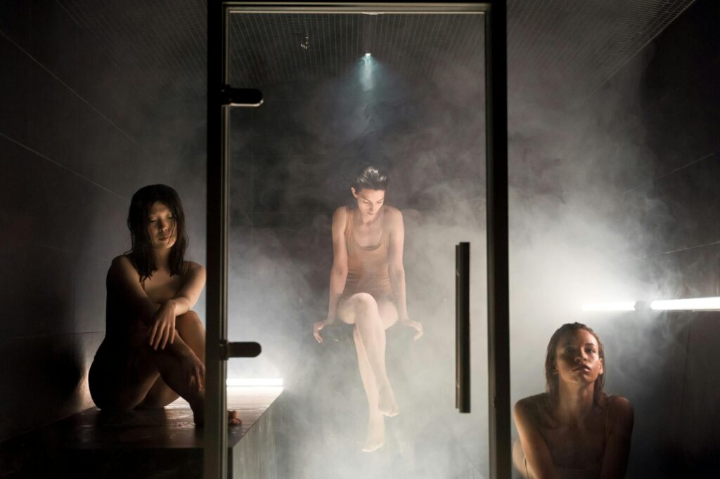 three women in a steam room